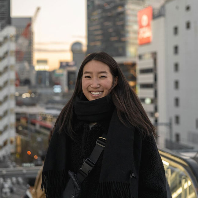 Photo of Juliana in front of Tokyo sunset.